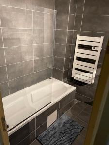 a bathroom with a shower with a bath tub at La maison jacuzzi - Privatiser une soirée jacuzzi in Mandres-les-Roses