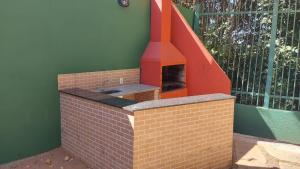 a brick oven in the corner of a house at Apartamento no Jardim botânico in Brasilia