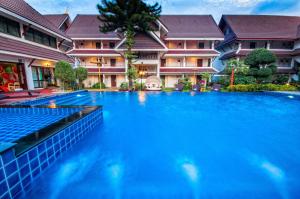 a swimming pool in front of some buildings at Nak Nakara Hotel in Chiang Rai +101 photos