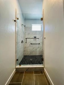 a bathroom with a shower with a glass door at Little Tokyo Hotel in Los Angeles