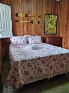 a bedroom with a bed with a computer mouse on it at Casa Apuaú in Novo Airão