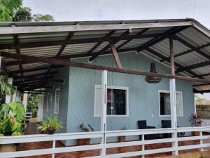 awning over a porch of a blue house at Casa Apuaú in Novo Airão