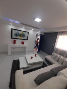 a living room with a couch and a table at Hermoso apartamento Residencial madera I in Santiago de los Caballeros