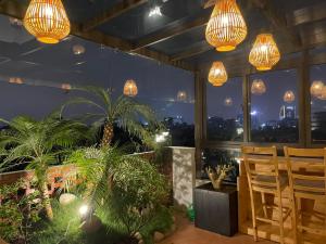a room with potted plants and chandeliers at Eco Nest in Hanoi