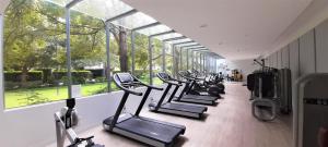 a row of treadmills in a gym with windows at beautiful apartment 100mts near the beach in Port Melbourne in Melbourne