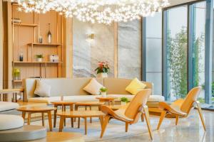 a living room with furniture and a chandelier at CM Serviced Apartment in Shenzhen