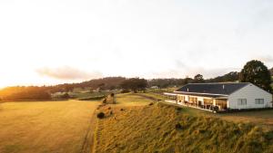 a house on a hill with a large field at Beechmont Estate in Beechmont
