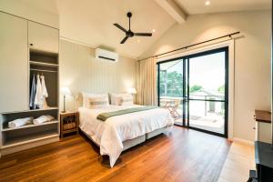 a bedroom with a bed and a large window at Beechmont Estate in Beechmont