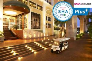 a shopping center with a small cart in front of a building at Nasa Bangkok - SHA PLUS Certified in Bangkok