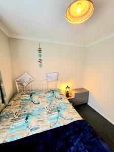 a bedroom with a large bed with a yellow ceiling at Holiday Chalet no289 in Withernsea