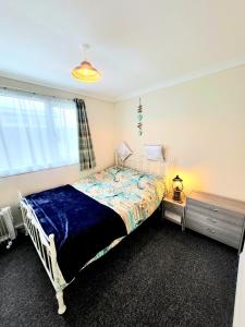 a bedroom with a bed and a window at Holiday Chalet no289 in Withernsea