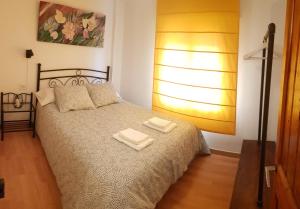a bedroom with a bed with two towels on it at EVA & TRAVEL - Cal Manco in Ulldemolins