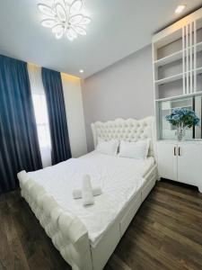a bedroom with a large white bed with two towels on it at Sunrise City 1 Bed Room in Ho Chi Minh City
