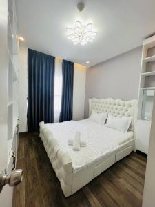 a white bedroom with a large white bed in a room at Sunrise City 1 Bed Room in Ho Chi Minh City
