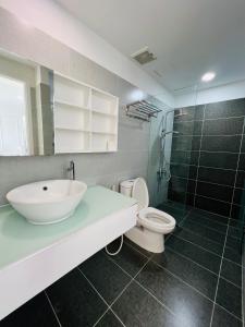 a bathroom with a sink and a toilet and a shower at Sunrise City 1 Bed Room in Ho Chi Minh City