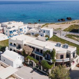 an aerial view of a white building next to the ocean at Apollon Hotel in Naxos Chora