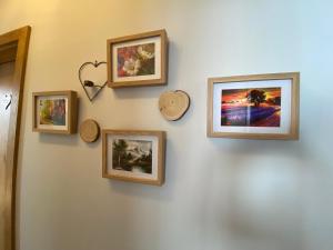 a wall with four framed pictures on a wall at Moderne Kaminstube in Ramsau am Dachstein