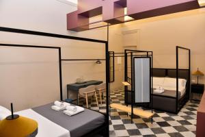 パレルモにあるMamamia al Teatro Biondoのベッド2台付きの部屋、テーブル付きのダイニングルームが備わります。