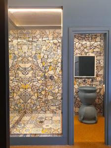 a bathroom with a mosaic wall with a toilet at Mamamia al Teatro Biondo in Palermo