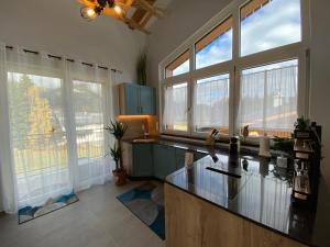 a kitchen with a counter top and some windows at Moderne Kaminstube in Ramsau am Dachstein