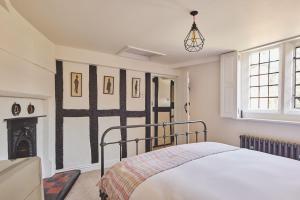 a bedroom with a bed and a fireplace at Lakeside Cottage in Nantwich