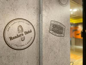 a wall with two stickers on it at Roaders Hotel Hualien Dongda in Hualien City +22 photos