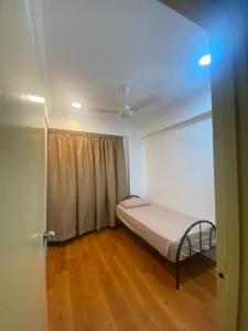 a small bedroom with a bed and a window at Teratak Nenda in Ampang