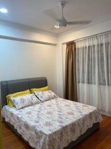 a bedroom with a bed with two pillows on it at Teratak Nenda in Ampang