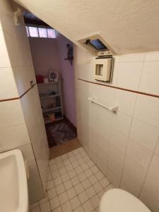 a small bathroom with a toilet and a sink at Casa MAMMUCCIA in Calascio