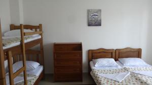 a bedroom with two bunk beds and a dresser at Hotel Ritsa in Ureki