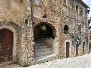 a stone building with stairs leading into a doorway at Casa MAMMUCCIA in Calascio