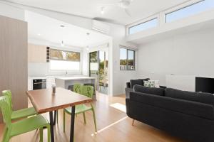 a living room with a couch and a table at Bay and Relax in Apollo Bay