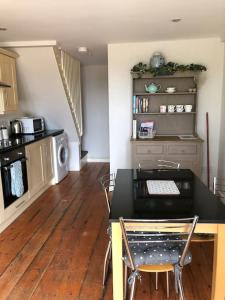 a kitchen with a table and chairs in a room at The Annexe in Sturminster Newton