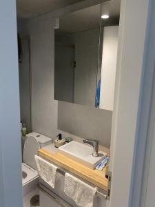 a bathroom with a sink and a toilet and a mirror at Corfudodici in Corfu Town