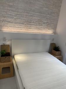 A bed or beds in a room at Corfudodici
