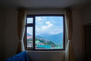 uma janela com vista para uma montanha em Citrus Boutique Hotel em Gangtok