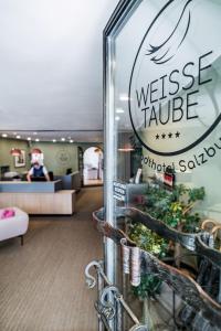 a lobby of a hotel with a sign for the westgate taksim village at Altstadthotel Weisse Taube in Salzburg