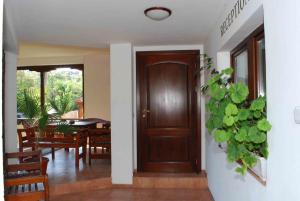 a hallway with a wooden door and a dining room at Guest House Katya in Nesebar