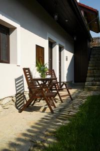duas cadeiras e uma mesa em frente a uma casa em Hezká chalupa 2.0 em Strmilov