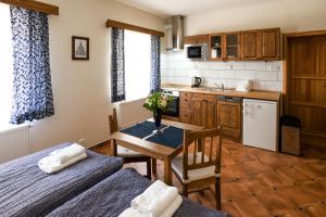a kitchen with a table and a dining room at Hezká chalupa 2.0 in Strmilov