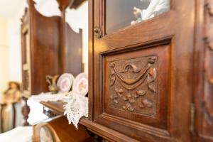 a wooden cabinet with a mirror on top of it at Villa Areto in Kamares