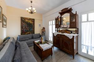 a living room with a couch and a large cabinet at Villa Areto in Kamares