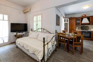 a bedroom with a bed and a dining room at Villa Areto in Kamares