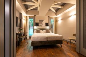 a bedroom with a bed and a table and chairs at Loly Boutique Hotel Roma in Rome +41 photos