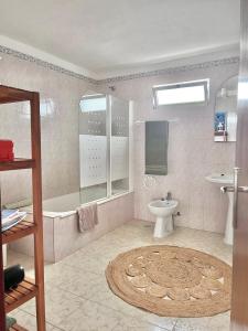 a bathroom with a tub and a toilet and a sink at Andorinha Levante in Grândola +25 photos