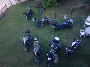 a group of motorcycles parked in the grass at Apartman Nadija in Jajce