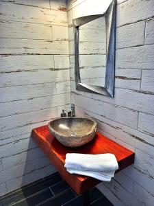 a bathroom with a sink and a mirror at Jalna Apartments - Stunning Sea & Mountain Views with pool - Kassiopi in Kassiopi