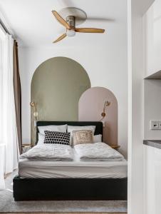 a bedroom with a bed with a green headboard at Luxury Apartments in East Side Gallery in Berlin