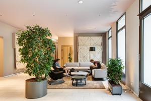 a group of people sitting in a living room at Arbio I Luxury Apartments in East Side Gallery in Berlin