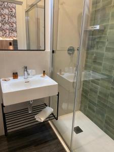a bathroom with a sink and a shower at Hotel Delle Camelie in Florence